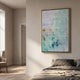 Clarique Green & Amber Vein Grid Acrylic 3D Wall Art in a gold frame, displayed on a cream wall above a linen bed in a sunlit neutral bedroom.