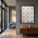 Stellure Taupe Brown & White Folded Acrylic 3D Wall Art by Giant Sculptures displayed above a teak sideboard in a modern grey living room with blue sofa.