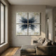 Volara Indigo Bloom Paper & Acrylic 3D Wall Art arranged as a four-panel grid of indigo, cream, and white butterfly forms above a taupe sofa in a sunlit living room.