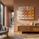 Dromara Amber Gradient Acrylic 3D Wall Art by Giant Sculptures displayed on a terracotta wall above an oak sideboard with books and a vase in a sunlit modern room.