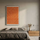 Parella Orange Slit Disc Grid Acrylic 3D Wall Art by Giant Sculptures, framed in black above a grey linen bed with an oak nightstand in a modern bedroom.