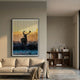Flutara Winter Dawn Stag Folded Acrylic 3D Wall Art with golden sky and blue foreground, framed in black, displayed above a cream sofa in a modern living room.