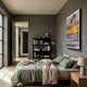 Flutara Ocean Blaze Sunset Folded Acrylic 3D Wall Art by Giant Sculptures mounted on a grey bedroom wall above a bed with sage linen and a black bookshelf.