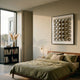 Refractura Chrome Mirror Disc Acrylic 3D Wall Art by Giant Sculptures displayed above a wooden bed with green linen in a modern bedroom with bookshelf.
