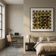 Refractura Gold Mirror Disc Acrylic 3D Wall Art by Giant Sculptures, framed in black above a bed and nightstand in a neutral bedroom with adjacent desk area.