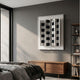 Gridure Black & White Panel Acrylic 3D Wall Art by Giant Sculptures displayed on a dark grey bedroom wall above a walnut sideboard beside a shelving unit.