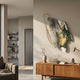 Aerava Emerald & Gold Sculptural Acrylic 3D Wall Art by Giant Sculptures, displayed above a wooden sideboard in a sunlit modern living room with bookshelf.
