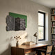 Strialux Flow Veil Green Leather & Acrylic 3D Wall Art by Giant Sculptures displayed above a walnut desk in a sunlit study with bookshelves.