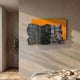 Strialux Flow Veil Amber Leather & Acrylic 3D Wall Art with black and white wavy stripes over an orange panel, mounted in a sunlit bedroom.
