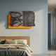 Strialux Mono Illusion Amber Leather & Acrylic 3D Wall Art by Giant Sculptures, with sculpted black-and-white ripple stripes on amber panel, above a bed.