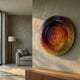 Vortara Sunset Spiral Gradient Acrylic 3D Wall Art by Giant Sculptures, mounted on a textured beige wall above a wooden console in a modern living room.