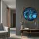 Aurenza Sapphire Acrylic & Metal Frame 3D Wall Art by Giant Sculptures, a textured teal and navy disc within an angled gold square frame, on a grey hallway wall.