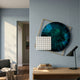 Aurenza Grid Sapphire Acrylic & Metal Frame 3D Wall Art by Giant Sculptures mounted on a pale blue wall above a wooden console with a black lamp and books.