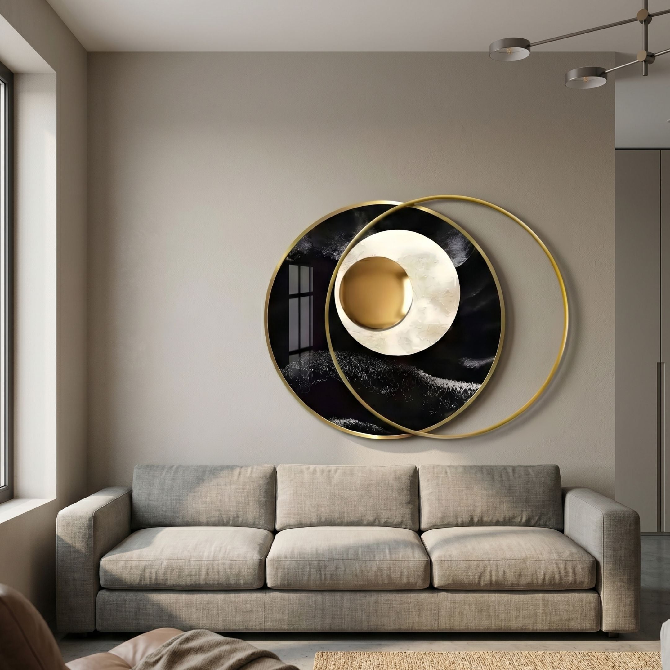 Giant Sculptures Solvata Obsidian Wave Orbit & Metal Ring 3D Wall Art with black disc, cream-gold core, and gold rings above a beige sofa in a living room.