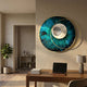 Solvata Deep Teal Orbit & Metal Ring 3D Wall Art by Giant Sculptures mounted above a walnut desk in a neutral home office with a potted plant nearby.