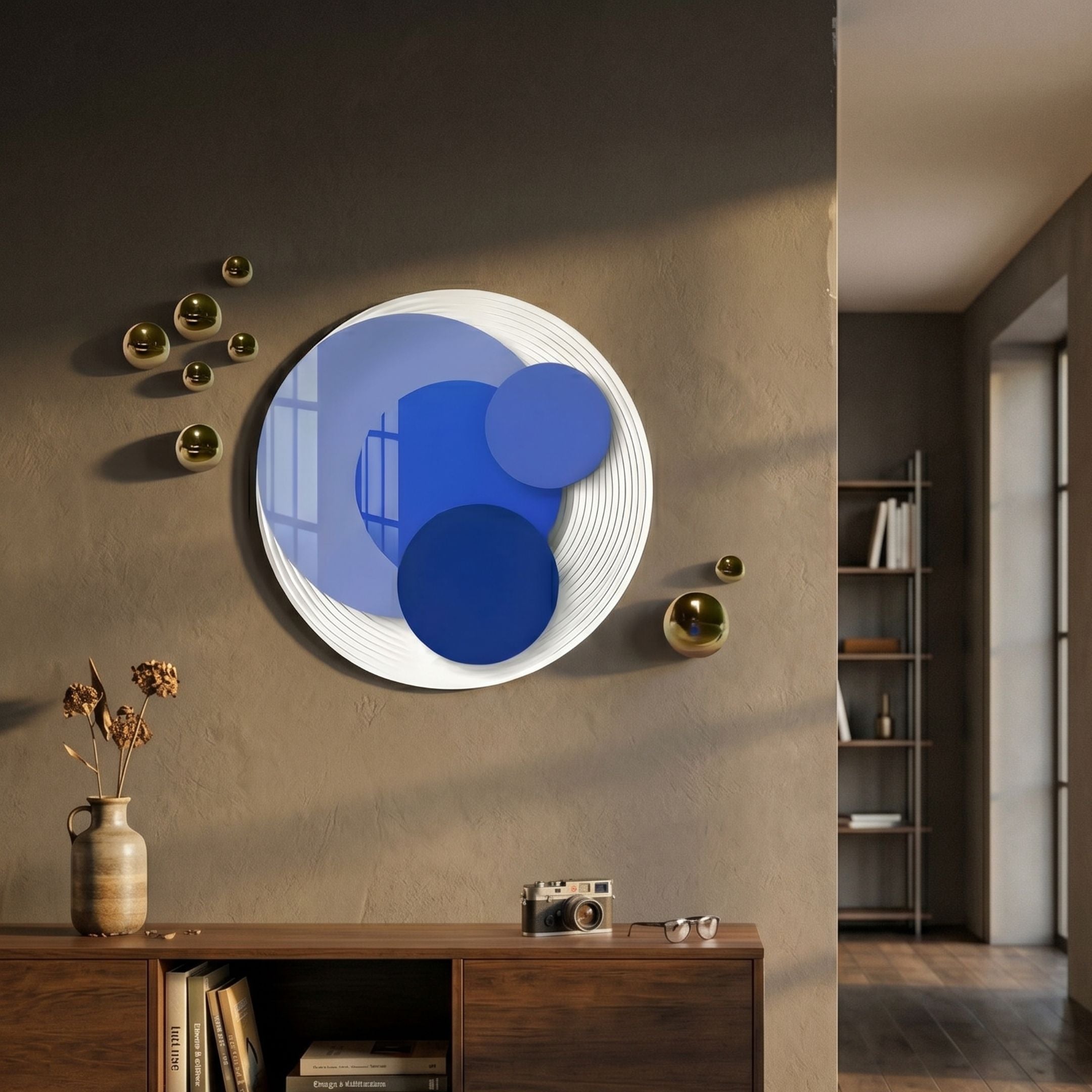 Cirelo Sky & Cobalt Disc Acrylic 3D Wall Art mounted above a wooden sideboard, flanked by gold metal spheres on a warm beige wall in a modern hallway.