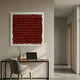 Frondra Brick Red Layered Leather 3D Wall Art by Giant Sculptures in a clear frame, mounted above a wooden desk with laptop, vase, and grey chair.