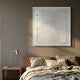 Lineora Layered Cream Paper 3D Wall Art by Giant Sculptures in a clear shadow box mounted above a wood-headboard bed with linen bedding and a bedside lamp.