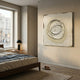 Textura Circular Orbit Relief 3D Wall Art by Giant Sculptures in beige with raised overlapping rings, displayed above a walnut bed beside a window.