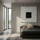 Textura Woven Grid Relief 3D Wall Art by Giant Sculptures, a white textured square with a central black panel, displayed above a bed in a minimalist bedroom.