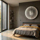 Lustara Silver Gradient Circular Leather 3D Wall Art mounted on a dark grey bedroom wall above a wooden bed with mustard and grey linens.