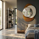 Solistra Amber I Layered Round Mirror 3D Wall Art by Giant Sculptures mounted on a dark grey bedroom wall above a bed, beside a shelving unit and window.