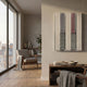 Tessella Black & Carmine Interwoven Yarn 3D Wall Art by Giant Sculptures, displayed on a beige wall above a wooden console in a sunlit living room with armchair.