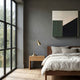 Tessella Olive & Black Interwoven Yarn 3D Wall Art by Giant Sculptures mounted on a grey bedroom wall above a walnut bed, beside a wooden nightstand and brass lamp.