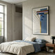 Grivaro Blue Grid & Stripe Sphere Leather 3D Wall Art by Giant Sculptures mounted above a linen-dressed bed with blue accents in a sunlit modern bedroom.