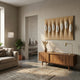 Virello Warm Ochre & White Disc Leather 3D Wall Art by Giant Sculptures mounted above a walnut sideboard in a neutral living room with sofa and plants.