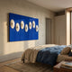 Virello Deep Blue & White Disc Leather 3D Wall Art by Giant Sculptures mounted above a linen-dressed bed in a Nordic bedroom with cream walls and oak floors.