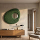 Aurec Green Textured Leather & Mirror 3D Wall Art by Giant Sculptures, displayed above a wooden sideboard with lamp and books in a neutral living room.