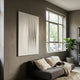Vallion Silver Folded Leather 3D Wall Art by Giant Sculptures displayed above a grey sofa in a modern living room with a large window and fiddle-leaf fig.