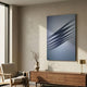 Vallion Blue Wave Folded Leather 3D Wall Art by Giant Sculptures mounted above a walnut sideboard with a vase and brass lamp in a sunlit living room.