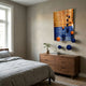 Orbentra Dual-Tone 3D Wall Art by Giant Sculptures mounted above a wooden dresser in a neutral bedroom, with blue and orange spheres trailing down the wall.