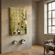 Orbentra Gold 3D Wall Art by Giant Sculptures, a ridged gold panel with scattered gold and chrome spheres, mounted in a plaster-walled room near an armchair.