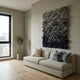 Liora Blue Ombre Ribbon Leather 3D Wall Art by Giant Sculptures, mounted above a beige sofa in a modern living room with an olive tree and window.