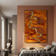Virethra Orange Layered Leather & Mirror 3D Wall Art mounted on a terracotta bedroom wall above a grey linen bed, beside a hallway view.