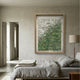 Florasca Green Ripple Leather 3D Framed Wall Art by Giant Sculptures displayed above a linen-dressed bed in a neutral bedroom with a floor lamp and open doorway.