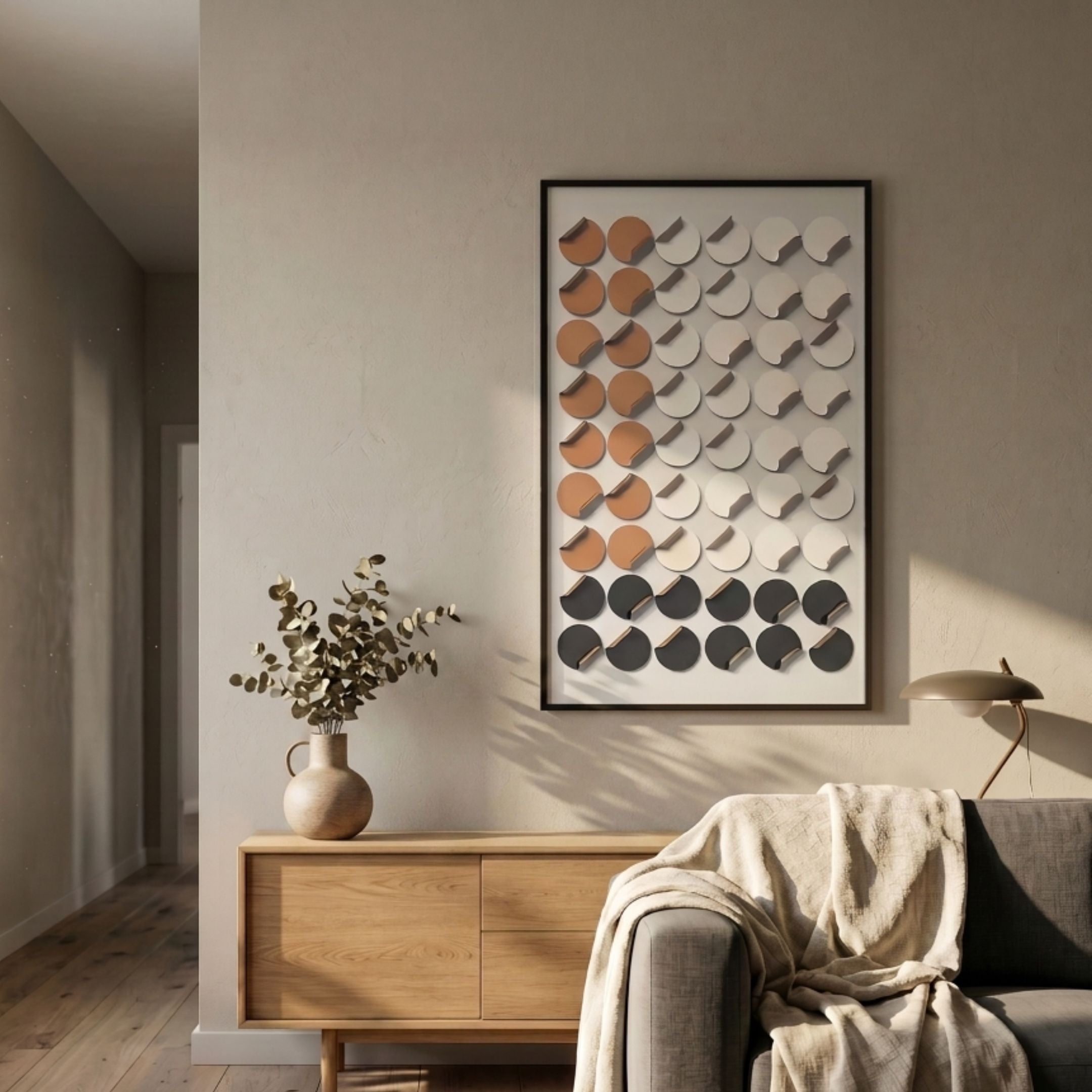Cirquon White, Grey & Tan Leather Curl Disc 3D Wall Art by Giant Sculptures displayed above an oak sideboard with a vase of eucalyptus in a living room.