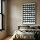 Cirquon Green Leather Curl Disc 3D Wall Art by Giant Sculptures displayed above a wooden bed with sage and grey linens in a modern bedroom.