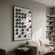 Cirquon White & Green Leather Curl Disc 3D Wall Art by Giant Sculptures displayed in a living room above a cream sofa beside a white bookshelf.