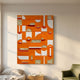 Moduvo Gold Accent Orange 3D Carving Wall Art by Giant Sculptures displayed above a bedside table and green armchair in a sunlit cream-walled room.