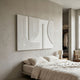 Lineaform Dual Curve Wood Carving 3D Wall Art by Giant Sculptures mounted above a linen-dressed bed in a neutral bedroom with an open wardrobe nearby.