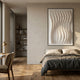 Velistra Modular Drift 3D Relief Wall Art in white, framed above a linen-dressed bed in a minimalist bedroom with wood floors and bookshelves.