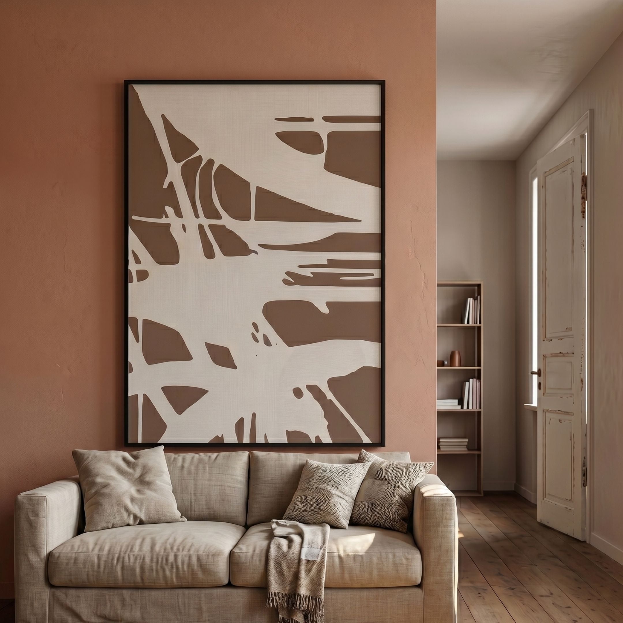 Deralin Mocha Trace Abstract 3D Carving Wall Art by Giant Sculptures in a black frame above a beige linen sofa against a terracotta wall in a sunlit living room.