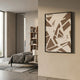 Deralin Mocha Angled Abstract 3D Carving Wall Art in mocha and cream tones, framed in black and mounted on a beige wall beside a modern bedroom.
