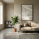 Deralin Taupe Trace Abstract 3D Carving Wall Art by Giant Sculptures in a black frame, displayed above a beige linen sofa beside a fiddle-leaf fig and low bookshelf.