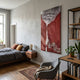 Virelai Crimson Abstract Oil Painting 3D Wall Art by Giant Sculptures hung above a wooden bed with grey linens in a Scandinavian bedroom with bookshelf.