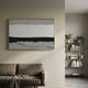 Stratisse Grey Layered 3D Carving Wall Art in a thin gold frame mounted above a brown sofa in a neutral living room with a bookshelf nearby.
